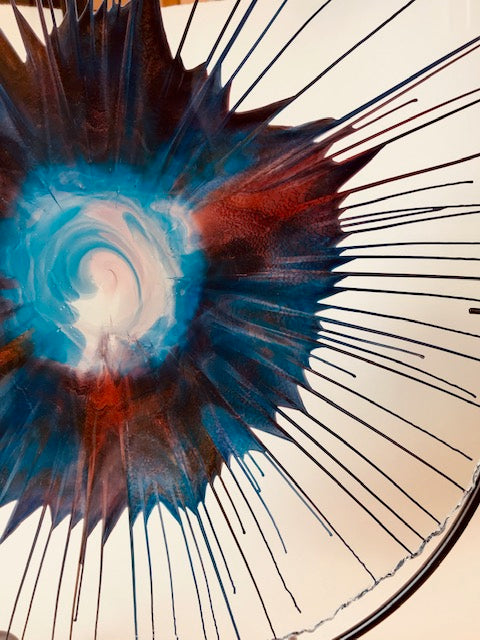 Award-winning artist Dennis DeBon creates exciting one-of-a-kind works of modern glass sculpture by combining the ancient art of reverse painting on live-edge glass with spin art. His work graces many private and public collections and has been featured in more than 35 galleries across the USA. Signed by the artist.