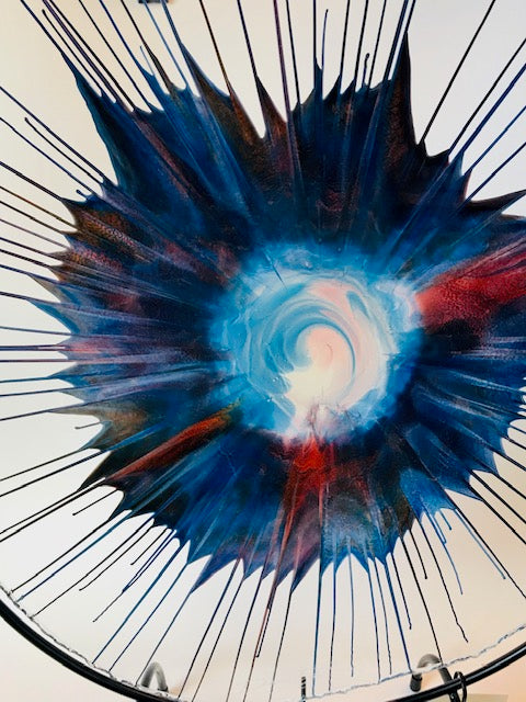 Award-winning artist Dennis DeBon creates exciting one-of-a-kind works of modern glass sculpture by combining the ancient art of reverse painting on live-edge glass with spin art. His work graces many private and public collections and has been featured in more than 35 galleries across the USA. Signed by the artist.