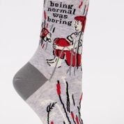 Woman's novelty fun crew sock with legend: "Being Normal Was Boring"