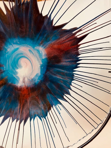 Award-winning artist Dennis DeBon creates exciting one-of-a-kind works of modern glass sculpture by combining the ancient art of reverse painting on live-edge glass with spin art. His work graces many private and public collections and has been featured in more than 35 galleries across the USA. Signed by the artist.